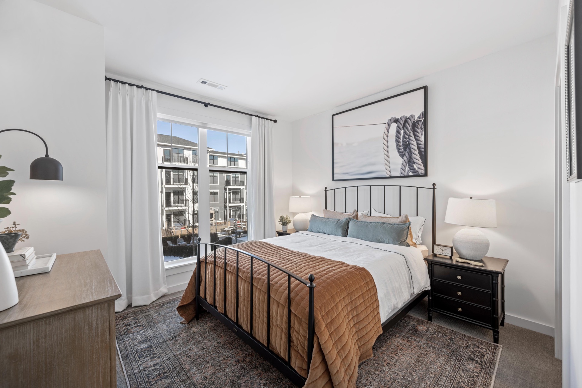 Elegant primary bedroom with natural light.